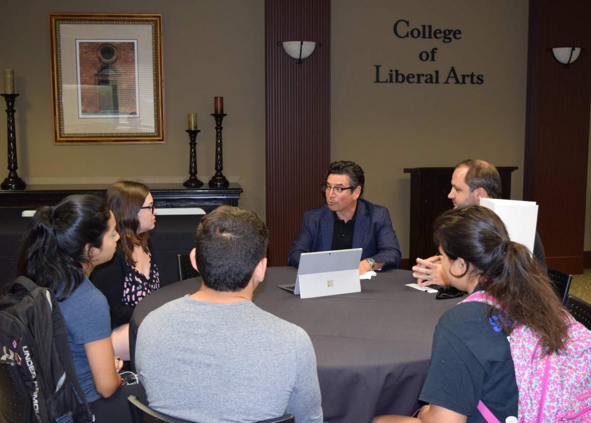 Dr. Longoria speaking with students